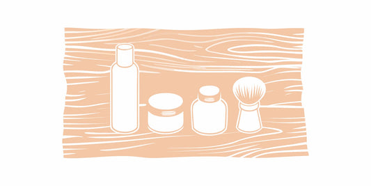 Premium American-made beard care products including beard oil bottles, balm tins, and grooming brush on a wooden surface
