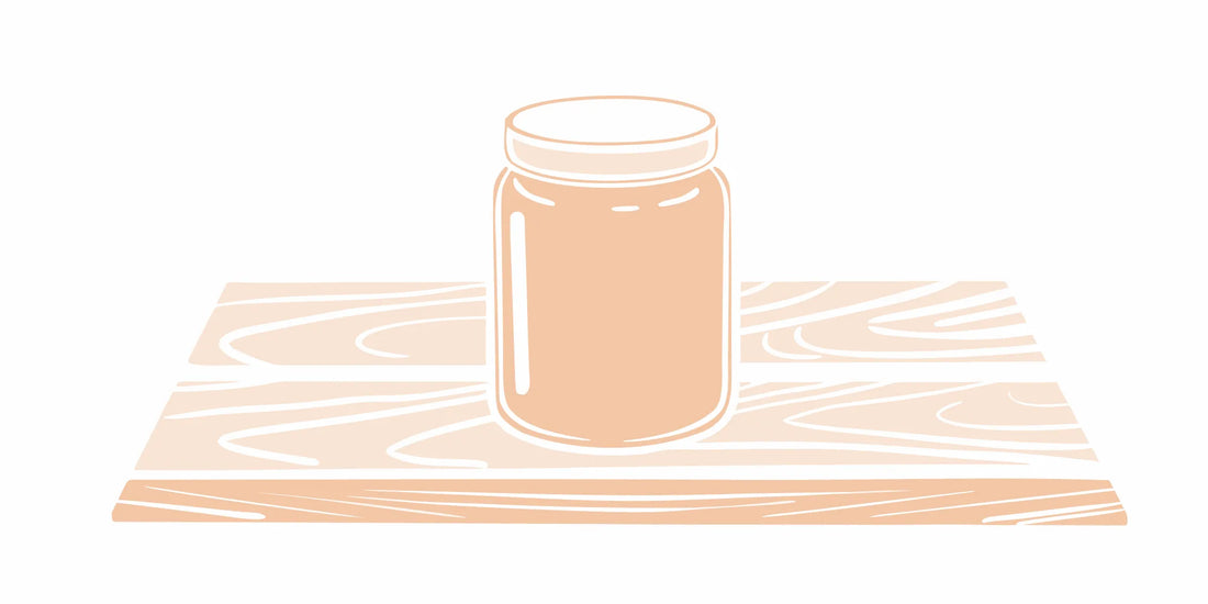 Premium grass-fed beef tallow balm in a glass jar on wooden surface