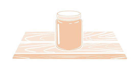Premium grass-fed beef tallow balm in a glass jar on wooden surface