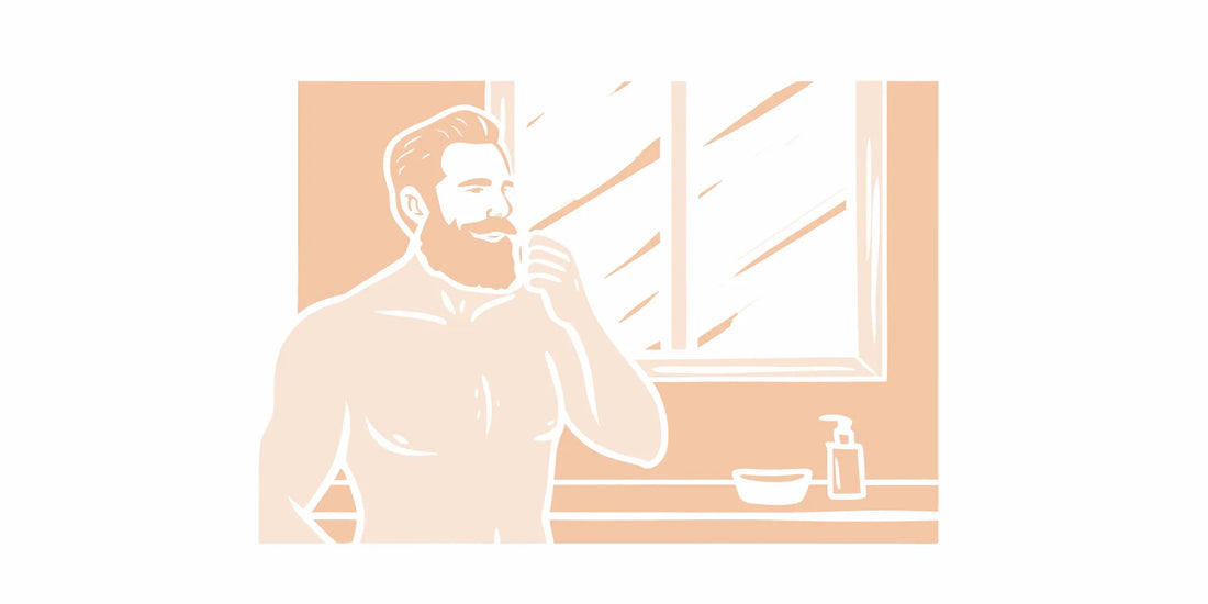 Man applying beard balm to a well-groomed beard in a bathroom with natural lighting