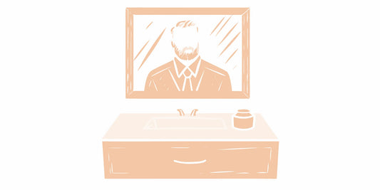 Man with a beard applying men's face cream in his bathroom.