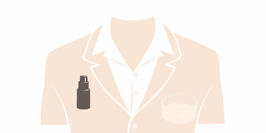 A bottle of men's skin conditioner next to a suit, an essential for men's skin.
