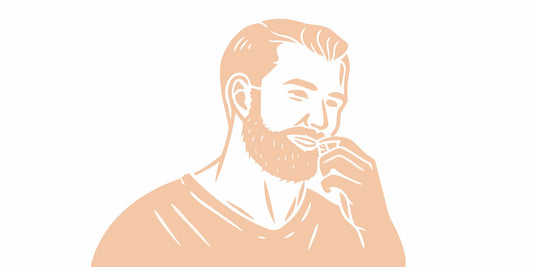 Man applying tallow beard balm outdoors in warm summer light