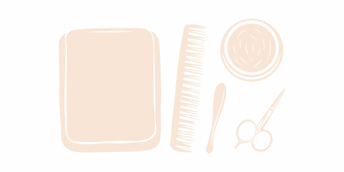 A tin of beard softening balm shown with grooming essentials like a comb, brush, and scissors.